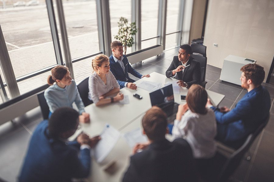 About Our Agency - Business Team Having a Success and Motivational Meeting at a Conference Table in the Office